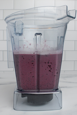 Blueberry smoothie blended in a blender.