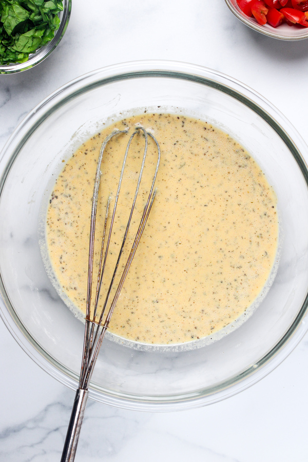 Water and olive oil whisked with the dry ingredients to form the chickpea flour muffin batter.