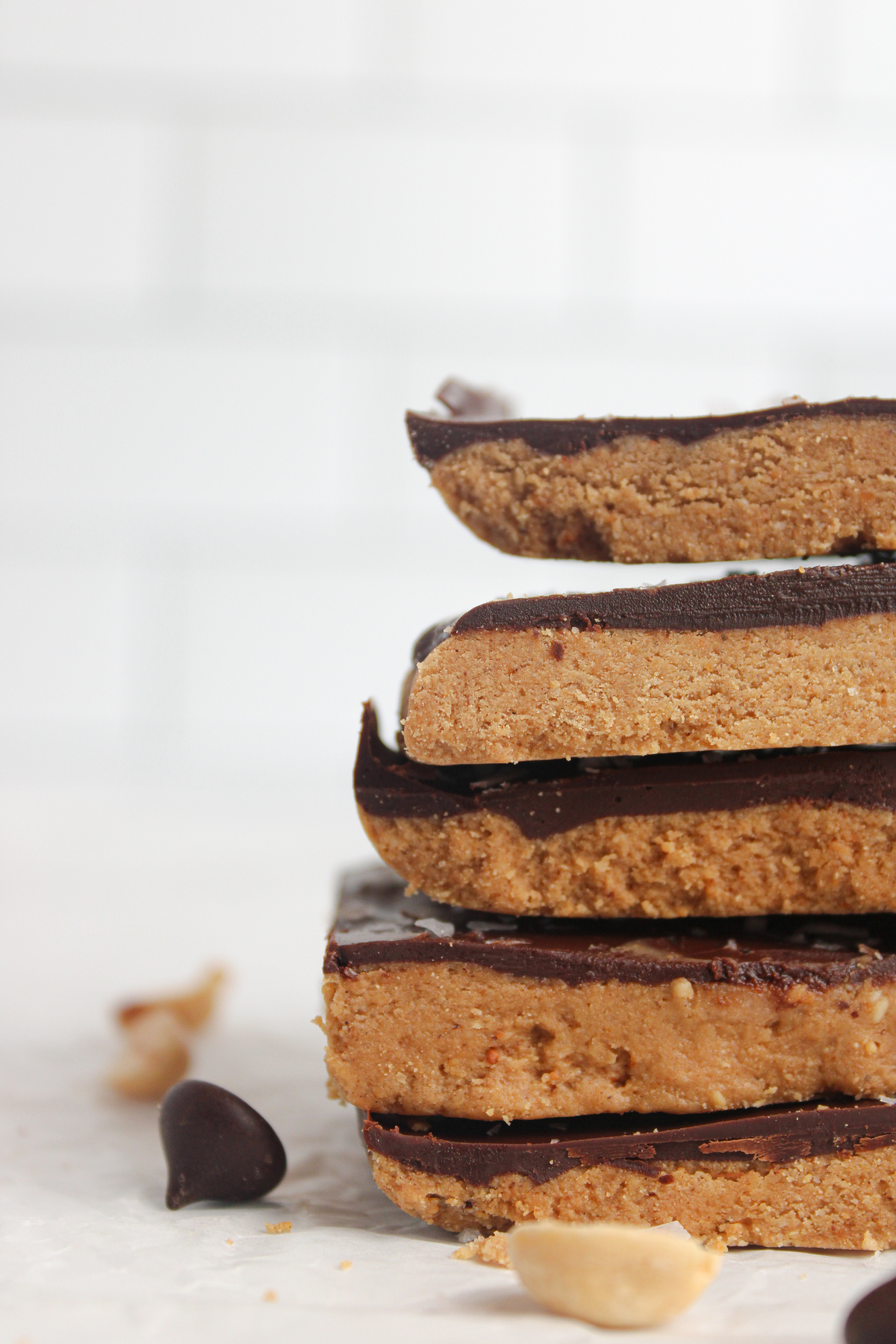 Straight-on close-up of protein bars, showing the soft peanut butter base and rich chocolate topping.