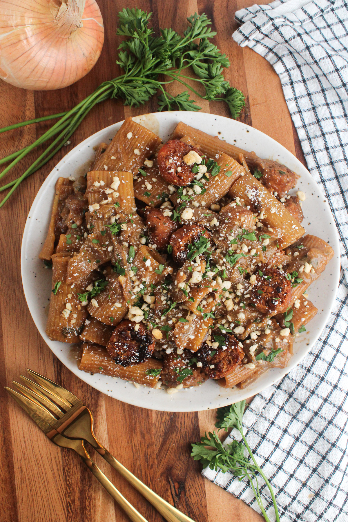 Overhead view of creamy pasta with caramelized onions in a rich sauce.