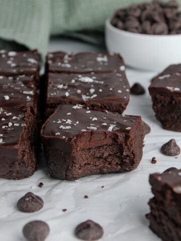Fudgy no-bake protein brownies topped with chocolate ganache and a sprinkle of flaky sea salt.