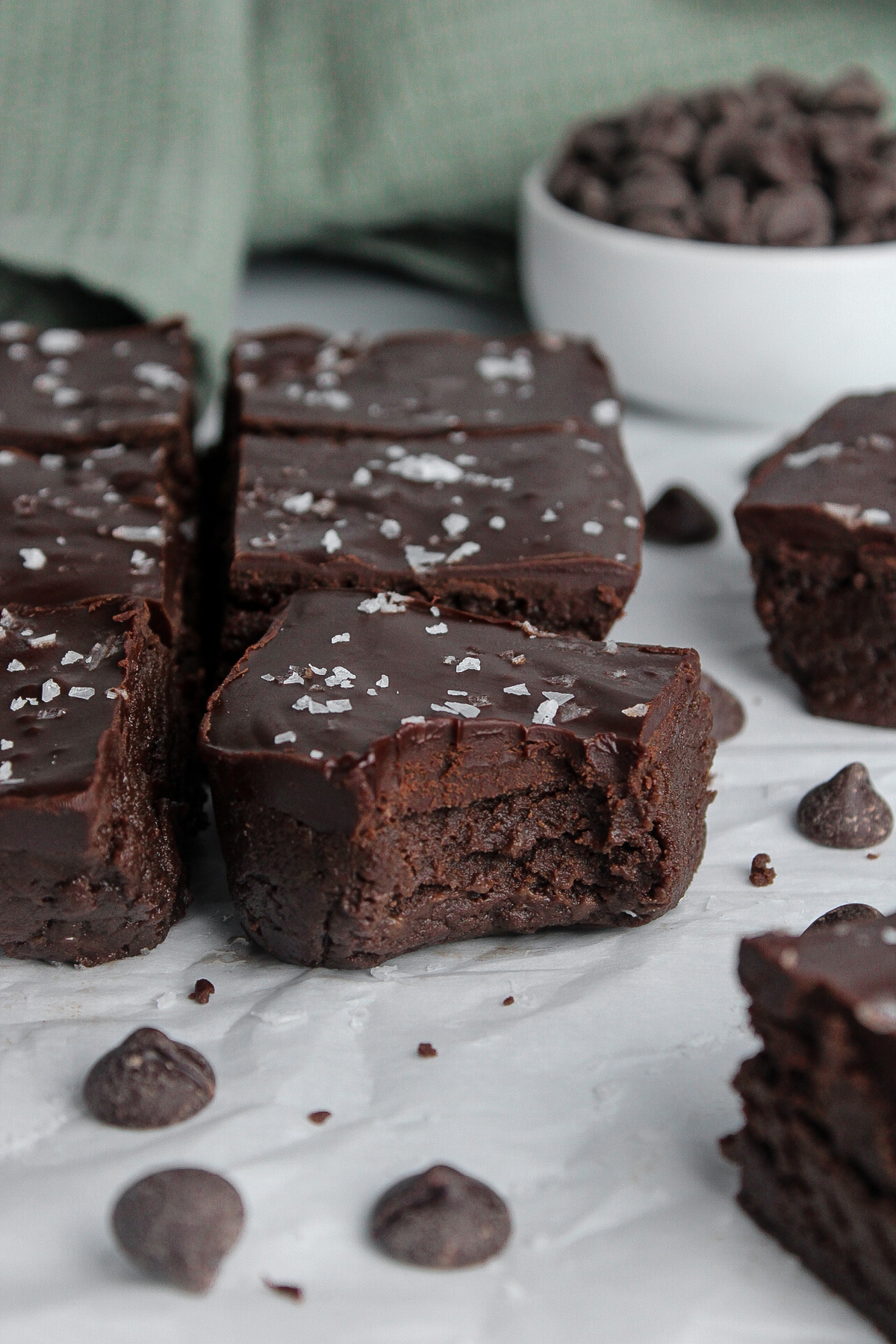 Fudgy no-bake protein brownies topped with chocolate ganache and a sprinkle of flaky sea salt.
