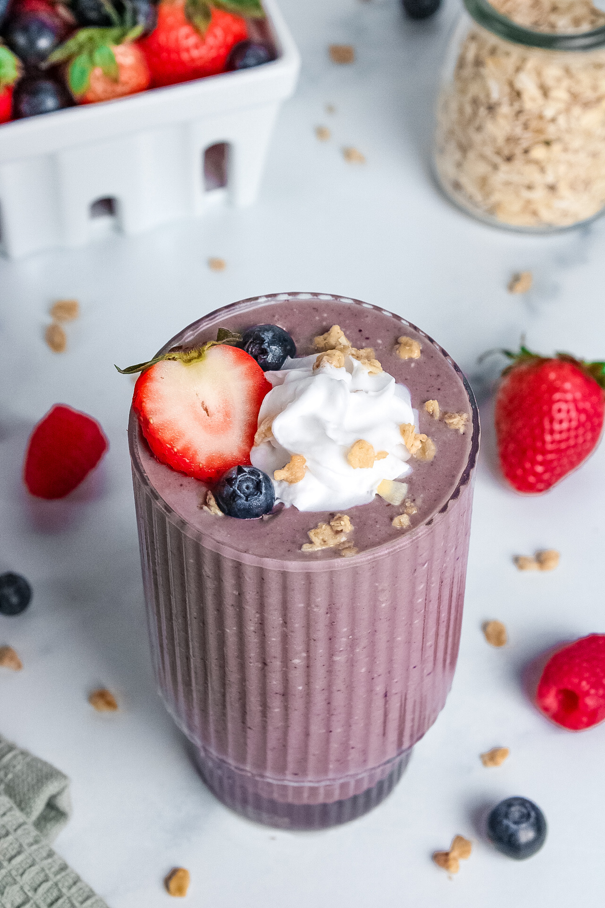 Vibrant purple berry pie smoothie in a glass, creamy and thick in texture.
