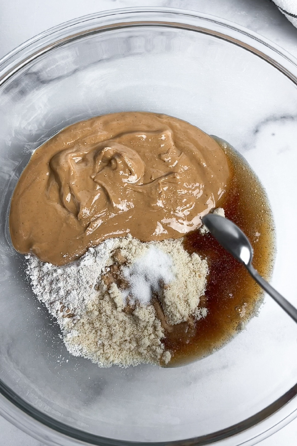 Cashew butter, almond flour, oat flour, maple syrup, vanilla extract, and salt combined in a large bowl.