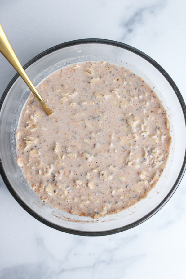 Peanut butter overnight oats ingredients mixed together with a spoon. 