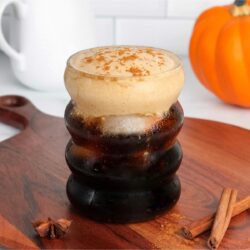 Glass of iced cold brew coffee topped with dairy-free pumpkin cream cold foam.