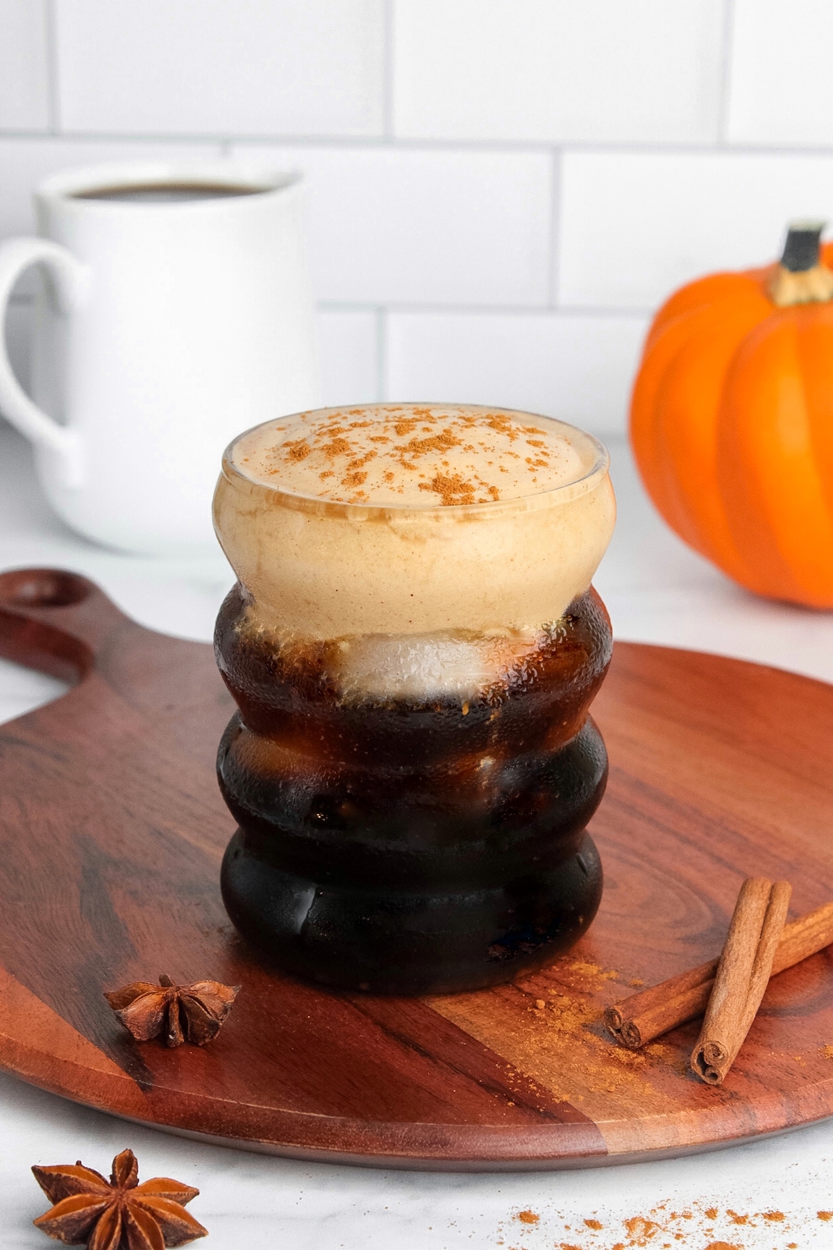 Glass of iced cold brew coffee topped with dairy-free pumpkin cream cold foam.