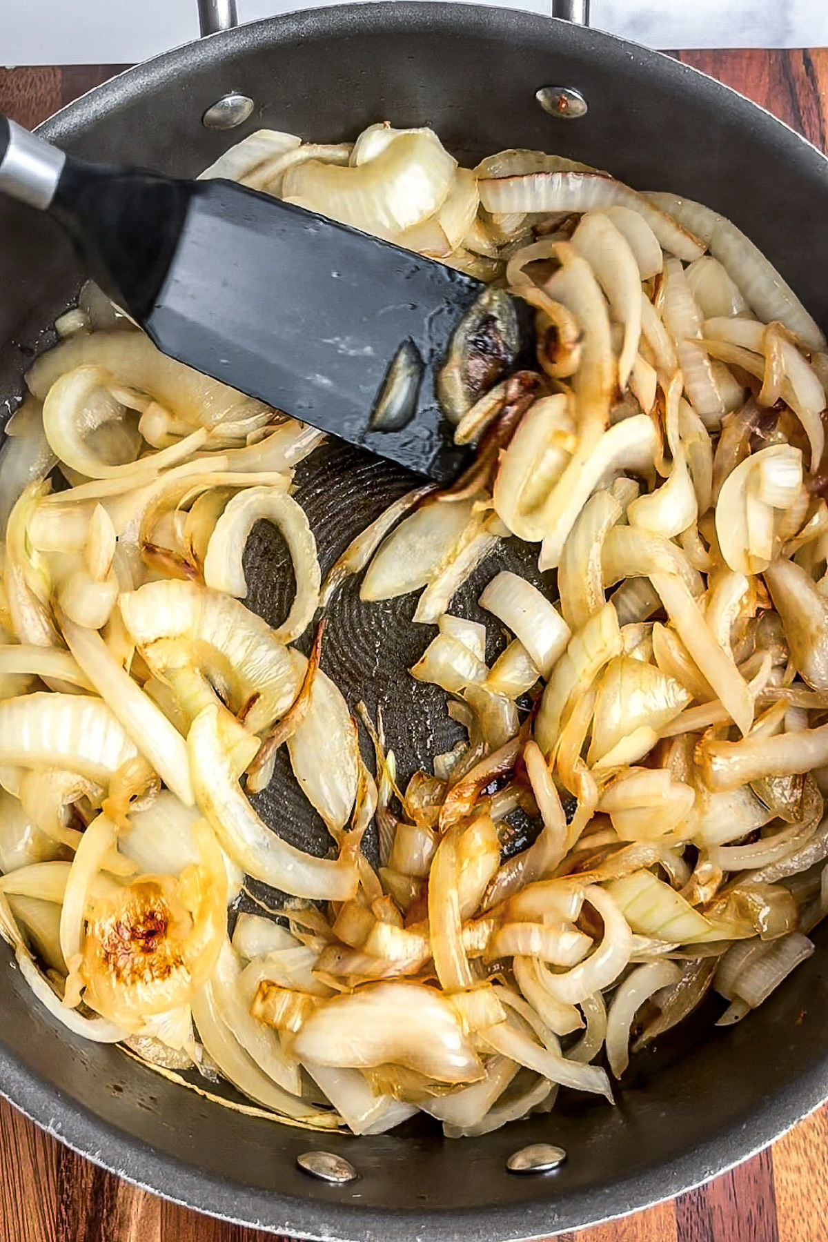 Onions softening and turning golden as they cook.