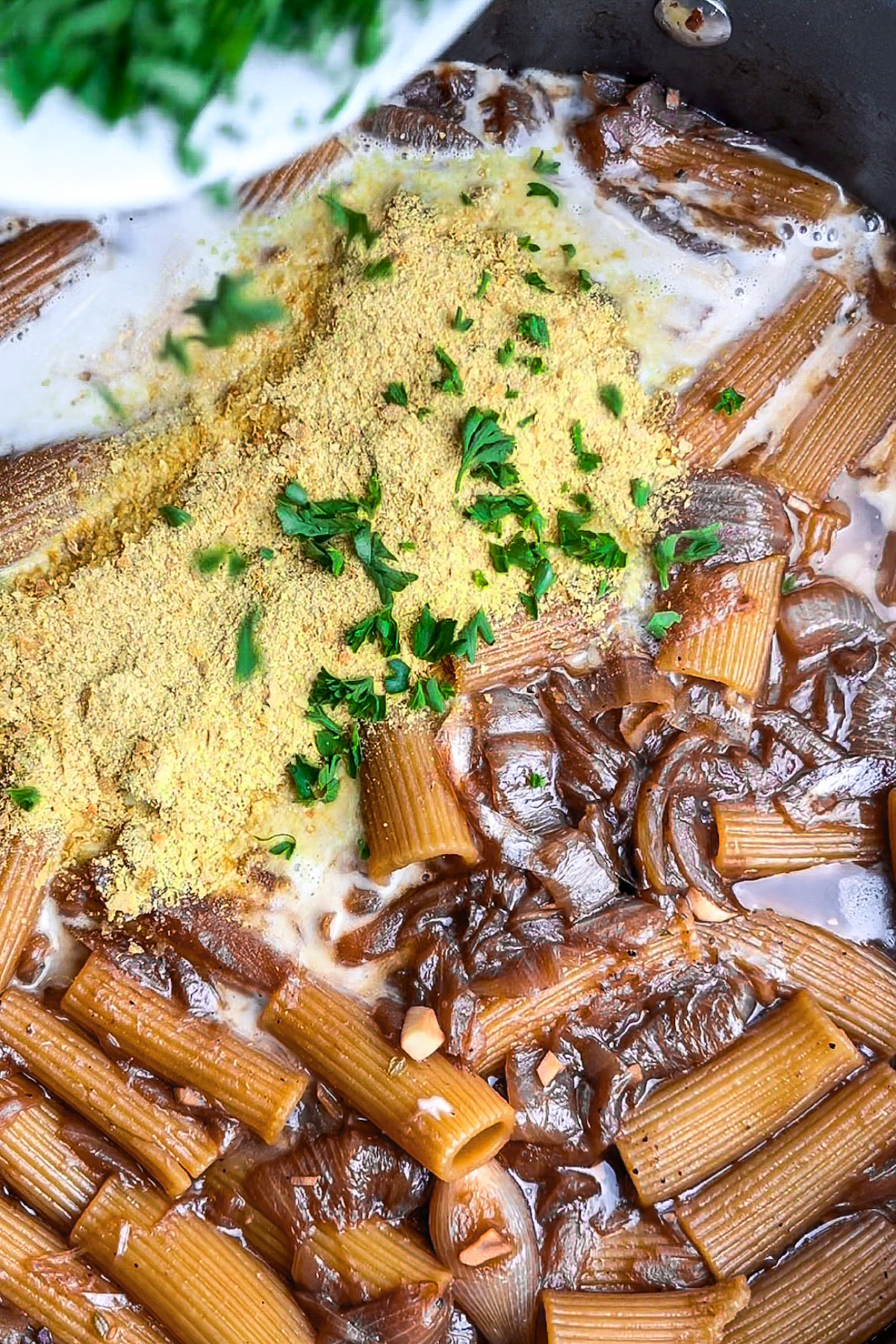 Coconut milk and vegan parmesan stirred into the French onion pasta.