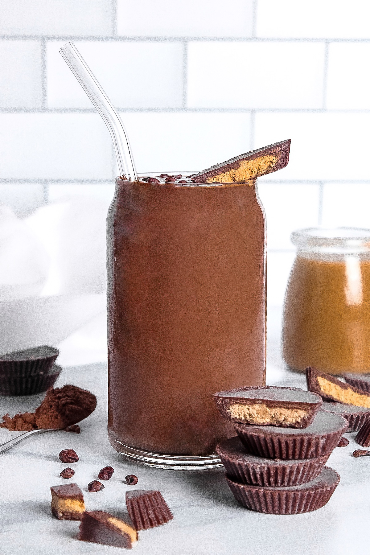 Straight-on view of a chocolate peanut butter smoothie topped with a peanut butter cup.