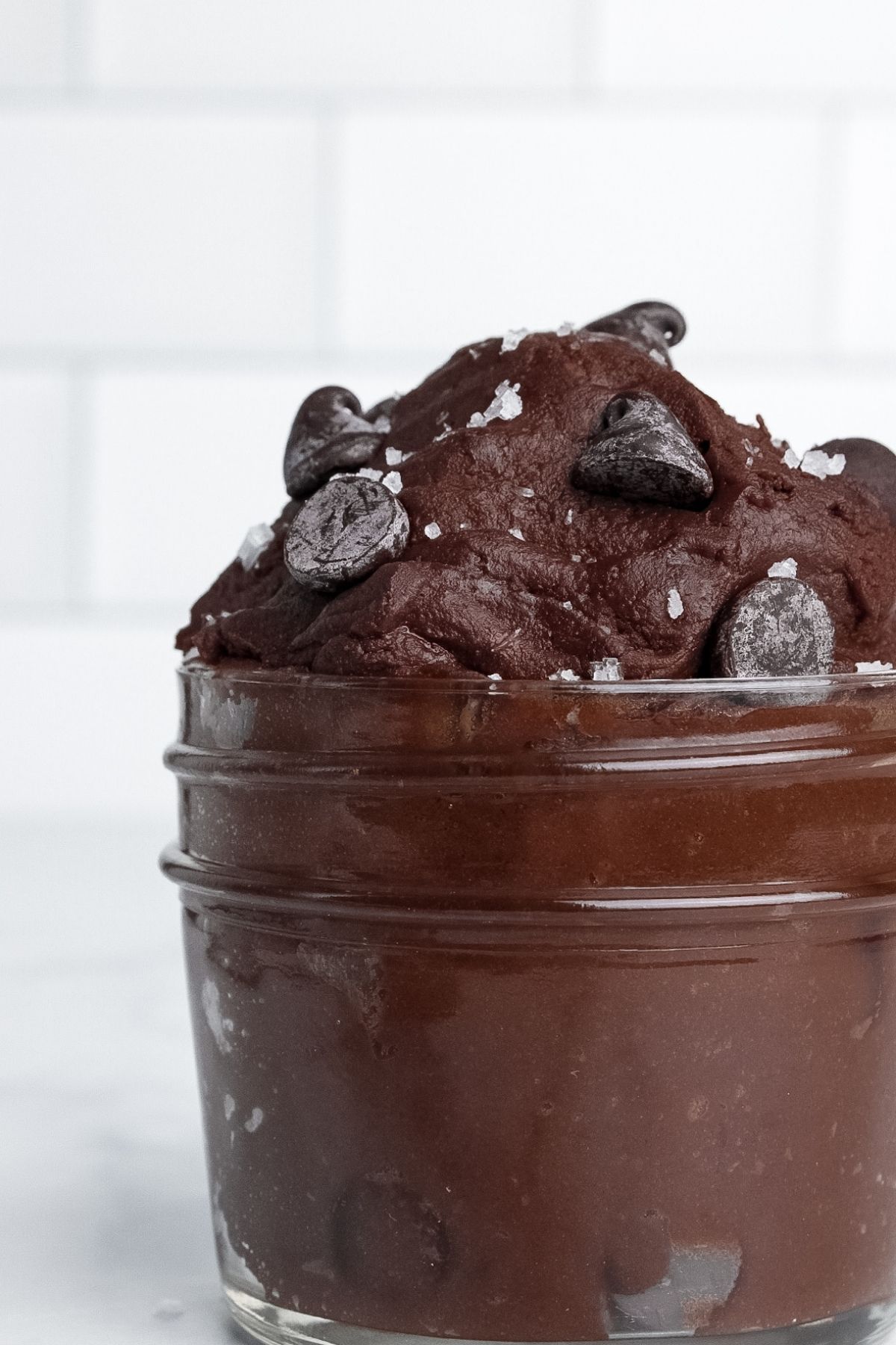 Close-up of high-protein brownie batter in a jar, showing its fudgy texture.