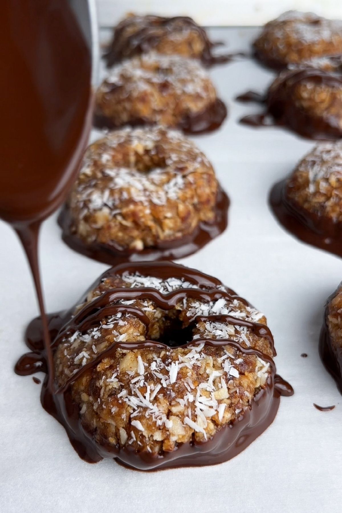 Drizzling melted chocolate over no-bake Samoa cookies.