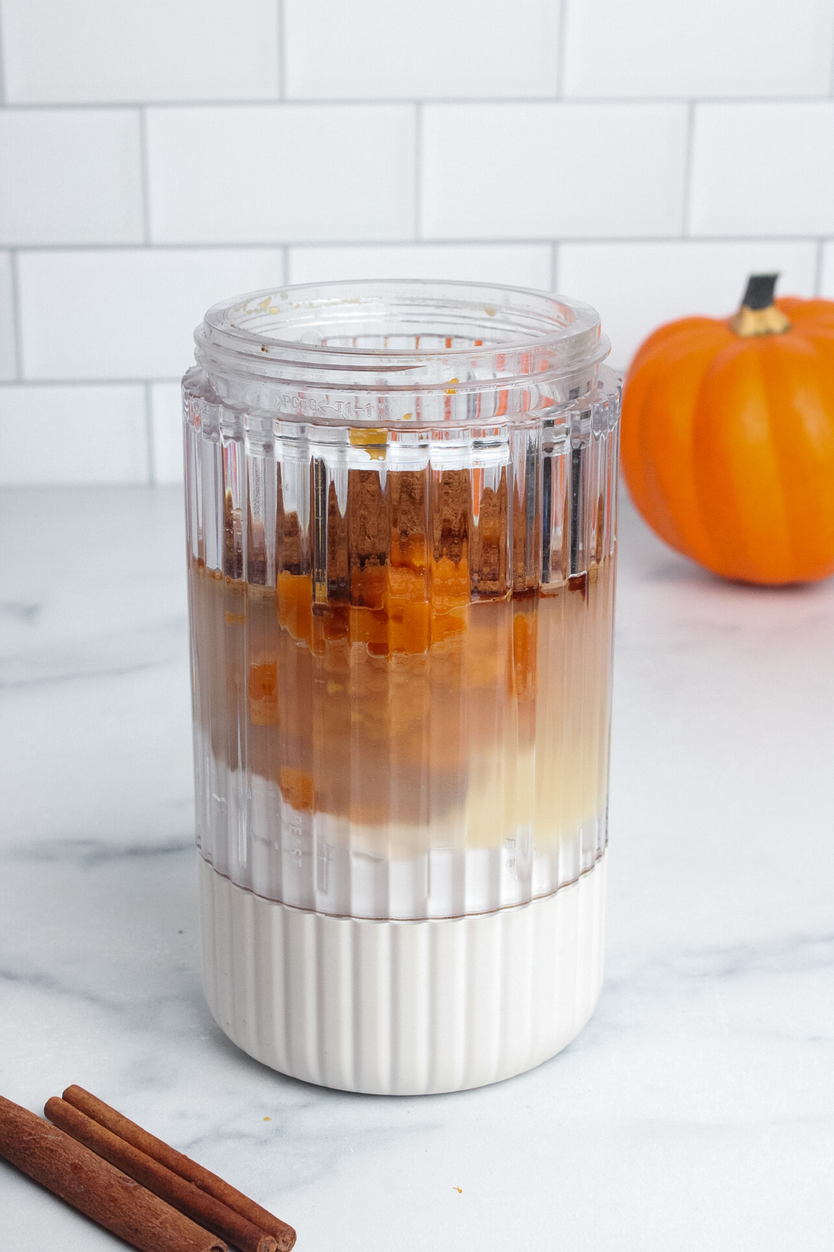All ingredients for dairy-free pumpkin cream cold foam in a blender.