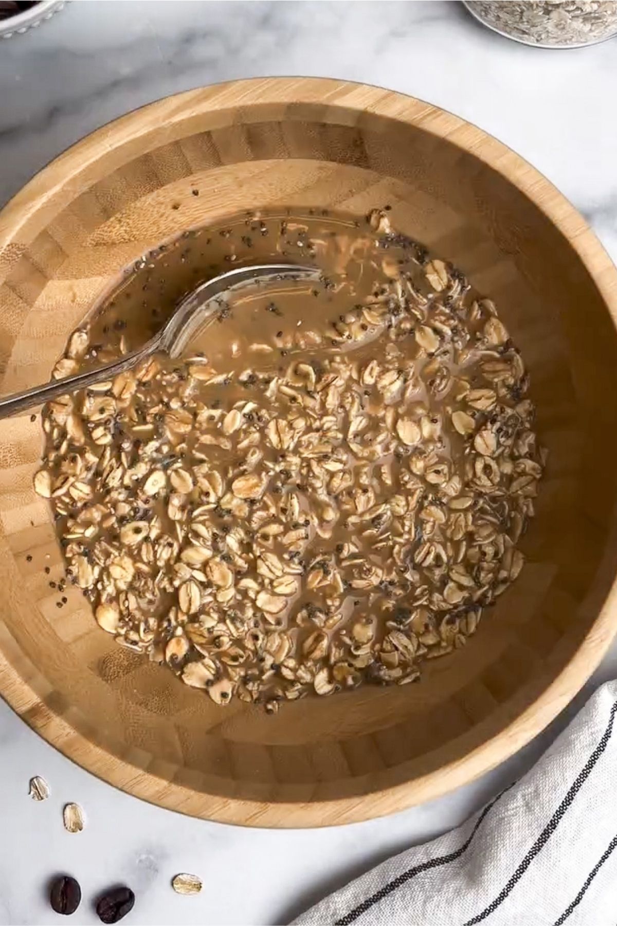 Coffee overnight oats mixed with a spoon.